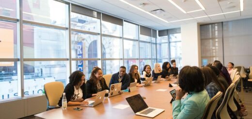 A diverse team of business professionals collaborating in a modern meeting room.