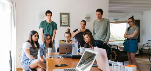 Group of young professionals engaged in a collaborative meeting in a modern office setting.