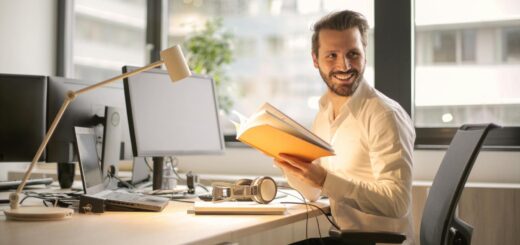 A relaxed businessman enjoying a break in his bright, contemporary office environment.